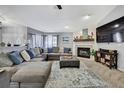 Spacious living room with a comfortable sofa, fireplace, and media center for relaxation at 13373 Lawrence St, Spring Hill, FL 34609