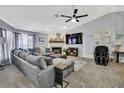 Inviting living room features a cozy sectional sofa, fireplace, and entertainment setup at 13373 Lawrence St, Spring Hill, FL 34609