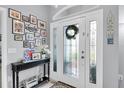 Warm foyer with decorative accents, a wreath, and a tiled floor at 13524 Knotty Ln, Hudson, FL 34669