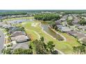 Aerial view of the golf course community showcasing the lush landscaping and winding water features at 1420 Winding Willow Dr, Trinity, FL 34655