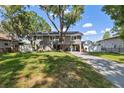 Inviting home with mature trees, fenced yard, and a spacious driveway for easy parking at 1700 Beachway Ln, Odessa, FL 33556