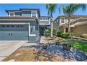 Beautiful two-story home featuring a large garage, well-manicured lawn, and charming curb appeal at 18061 Glastonbury Ln, Land O Lakes, FL 34638