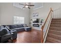 Bright and airy living room with a high ceiling, fan, large windows, and a staircase at 18061 Glastonbury Ln, Land O Lakes, FL 34638