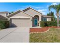 Charming single-Gathering home featuring a well-kept lawn, front shrubs, and an attached two-car garage at 1810 Winsloe Dr, Trinity, FL 34655