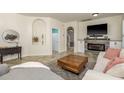 Cozy living room with tiled floors, a fireplace, and a comfortable seating area, great for relaxing at 1810 Winsloe Dr, Trinity, FL 34655