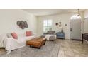 Inviting living room featuring tiled floors, comfortable seating, and abundant natural light at 1810 Winsloe Dr, Trinity, FL 34655