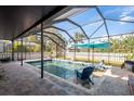 Relaxing screened-in pool area with comfortable seating, perfect for outdoor entertaining and leisure at 1810 Winsloe Dr, Trinity, FL 34655