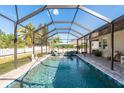 Sparkling pool area featuring a screened enclosure and inviting lounge area at 1810 Winsloe Dr, Trinity, FL 34655