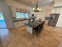The eat-in kitchen has white cabinets, a dark island, and modern stainless steel appliances at 210 S Hale Ave, Tampa, FL 33609