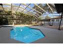A beautiful screened-in pool with a hot tub and lovely landscaping provides a private backyard oasis at 210 S Hale Ave, Tampa, FL 33609