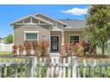Charming home with landscaped front yard with a white picket fence in a well-maintained neighborhood at 21167 Pleasant Plains Pkwy, Land O Lakes, FL 34637