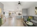 Open-concept living area features tile flooring, a comfortable sofa, and a view of the dining and kitchen area at 21167 Pleasant Plains Pkwy, Land O Lakes, FL 34637