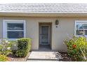 Home entrance featuring a well-maintained landscape and tiled entryway at 3819 Teeside Dr, New Port Richey, FL 34655