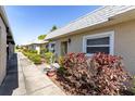 Exterior view of the home with lush landscaping along the walkway at 3819 Teeside Dr, New Port Richey, FL 34655