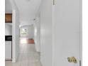 Hallway with tile floors and access to kitchen and living areas at 3819 Teeside Dr, New Port Richey, FL 34655