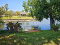 Scenic backyard view featuring lush greenery and direct access to a serene canal at 4264 Tamargo Dr # 3, New Port Richey, FL 34652