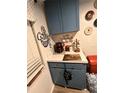 Practical coffee bar featuring stylish blue cabinets, white countertops and coffee-themed décor at 4264 Tamargo Dr # 3, New Port Richey, FL 34652