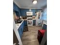 Cozy kitchen with blue cabinets, modern appliances, and functional layout at 4264 Tamargo Dr # 3, New Port Richey, FL 34652