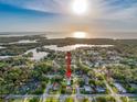 A waterfront property sits amid lush trees in a neighborhood setting, perfect for serene living at 4934 Amherst Ct, New Port Richey, FL 34652