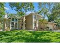 Stunning exterior view of a two-story home with a lush lawn and mature trees providing ample shade at 520 Lafayette Blvd, Oldsmar, FL 34677