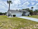 Charming single-story home featuring a two-car garage and well-manicured landscaping at 7538 Landmark Dr, Spring Hill, FL 34606