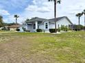 Charming single-story home featuring a two-car garage and well-manicured landscaping at 7538 Landmark Dr, Spring Hill, FL 34606