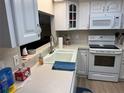 Bright kitchen with white cabinetry, modern appliances, and a functional layout perfect for cooking and entertaining at 7708 Obrien Ct, Hudson, FL 34667