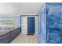 Entryway featuring a blue antique cabinet, tiled floors and front door at 800 N Walton Ave, Tarpon Springs, FL 34689