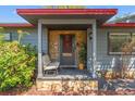 Inviting front porch with stone accents, seating, and a charming entrance at 800 N Walton Ave, Tarpon Springs, FL 34689