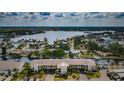 Aerial view of waterfront condo building located on a canal, with boat docks and parking at 8210 Aquila St # 218, Port Richey, FL 34668