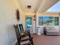 Welcoming front porch with comfortable seating, decorative wall accents, and an inviting entrance at 8600 N Briar Patch Dr, Port Richey, FL 34668