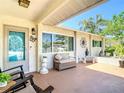 Spacious front porch features seating, decorative elements, and a view of the well-maintained exterior at 8600 N Briar Patch Dr, Port Richey, FL 34668