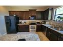 Well-equipped kitchen with dark wood cabinets, stainless steel appliances, and a stylish island at 9007 49Th E Ave, Palmetto, FL 34221