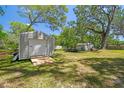 Backyard shed with roll-up door and ramp at 9226 Dan Lynn St, Brooksville, FL 34601