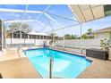 Inviting screened-in pool with clear blue water, perfect for relaxing and entertaining at 12040 Penzance Ln, New Port Richey, FL 34654
