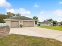 Spacious three-car garage with a wide driveway and well-maintained exterior at 13052 Drysdale St, Spring Hill, FL 34609
