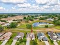 Aerial shot highlighting the home's location near a scenic pond and golf course, offering a picturesque community setting at 13618 Niti Dr, Hudson, FL 34669
