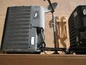 Outdoor AC unit, satellite dish, and electric box on exterior wall, close up view at 1514 Citrine Trl, Tarpon Springs, FL 34689