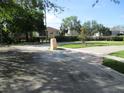 Corner lot with neatly kept grounds, a brick paved entrance, and mature shade trees at 1514 Citrine Trl, Tarpon Springs, FL 34689