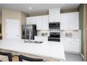 Bright kitchen featuring stainless appliances, pendant lighting, and bar seating at 20334 Lou Angela Ln, Lutz, FL 33558
