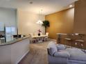 Open-concept dining area with elegant chandelier, breakfast bar, and a view of the adjacent kitchen at 21008 Sunpoint Way # 204, Lutz, FL 33558