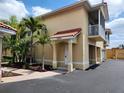 Attractive two-story home with a charming entrance, private balcony, and attached garage at 21041 Sunpoint Way # 202, Lutz, FL 33558