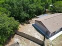 Aerial view of the backyard with a wooden fence and mature trees offering plenty of privacy at 2660 Orangewood Ct, Palm Harbor, FL 34684