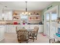 Eat-in kitchen featuring granite countertops, pendant lighting, and adjacent dining area at 3340 Oleander Dr, Hernando Beach, FL 34607