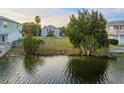 A beautiful view of a waterfront property with lush greenery and serene water reflecting the sky at 3340 Oleander, Hernando Beach, FL 34607
