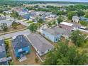 Neighborhood aerial view showcasing homes with lush landscaping, sidewalks, and a serene environment at 3410 Thistledown Ln, Land O Lakes, FL 34638