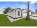 Stylish single-story home showing the side and front exterior with a neatly landscaped yard at 3410 Thistledown Ln, Land O Lakes, FL 34638