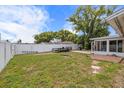 Backyard showing the white vinyl fence and space for a barbeque or outdoor activities at 3638 Bigelow Dr, Holiday, FL 34691