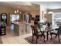 Bright, open kitchen featuring a large island with countertop seating, stainless steel appliances, and ample cabinetry at 4047 Eagle Cove West Dr, Palm Harbor, FL 34685