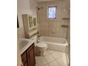Tiled bathroom with tub, vanity, and decorative stained glass window at 4534 Irene Loop, New Port Richey, FL 34652